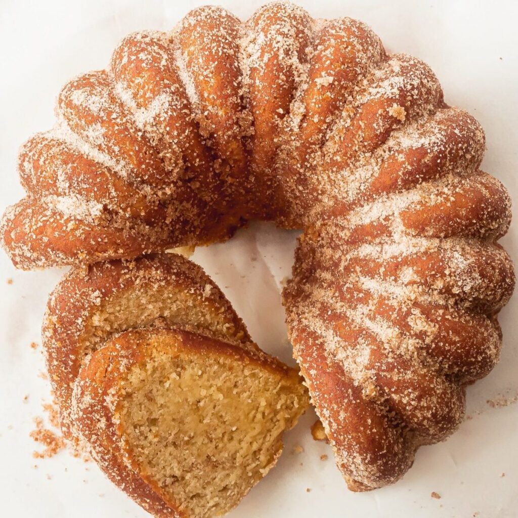 donut cake sliced and placed on wooden counter 