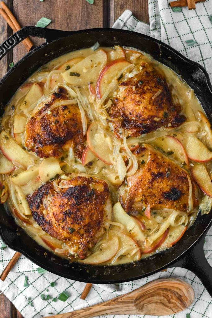 chicken and apples in a cast iron skillet 