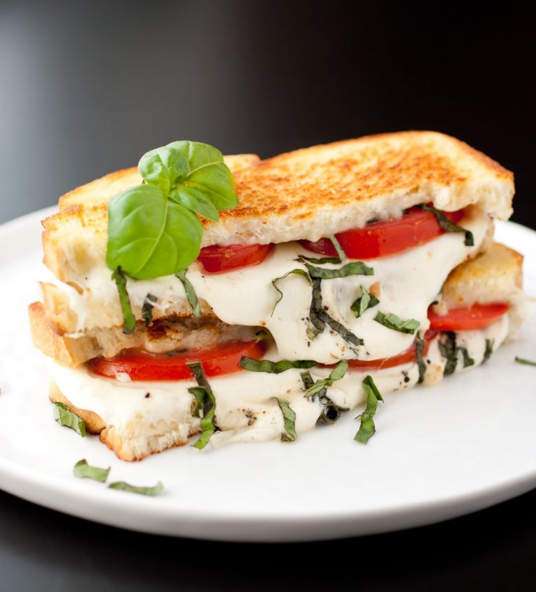 a caprese grilled cheese on plate on table