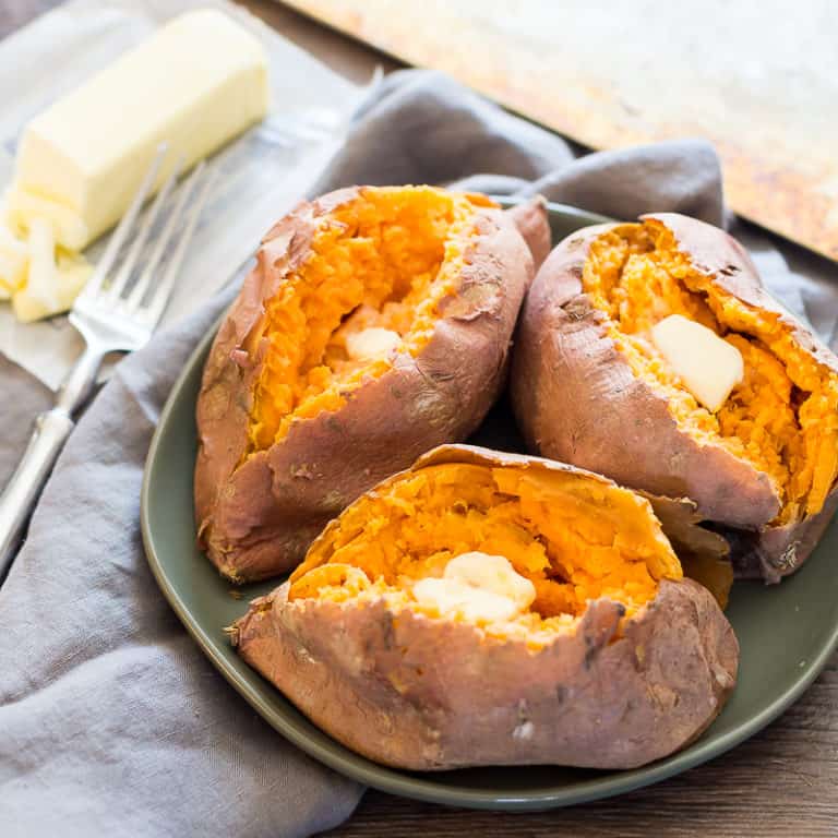 sweet potatoes on a plate with butter on side 
