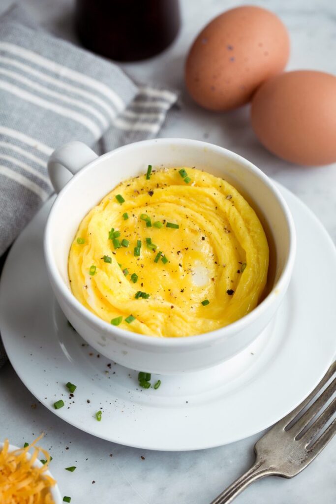 overhead shot of eggs in a mug on table 