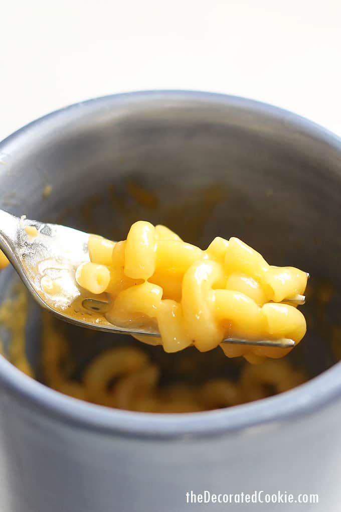 fork with macaroni and cheese on it 