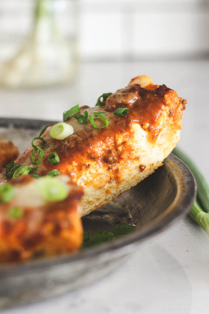 chili cheese bread on a plate with pepper on side 