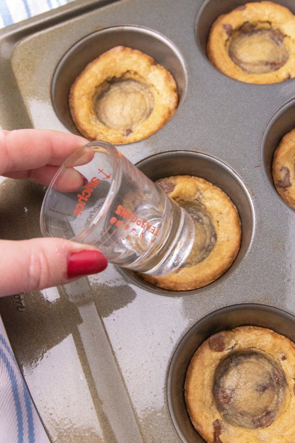 shot glass pressing into the cookie cup 
