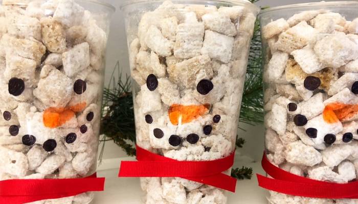 muddy buddies in a snowman decorated clear cup