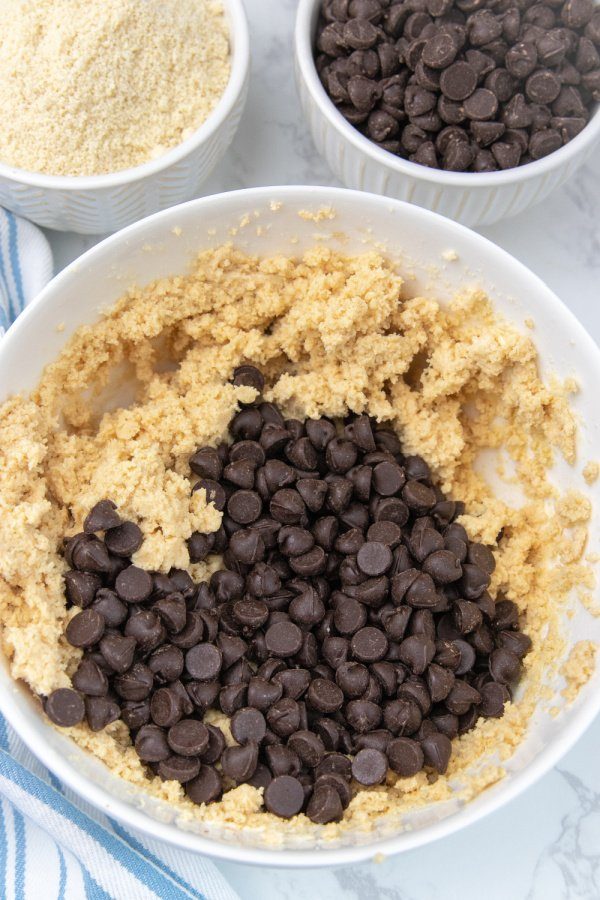 Keto cookie dough fat bombs is a great way to fuel your body and enjoy a sweet treat to break up the day. Simple ingredients is all it takes. #passion4savings #keto #cookiedough #fatbomb #ketorecipe #easy #best #homemade #fromscratch fat bomb ingredients in a white bowl