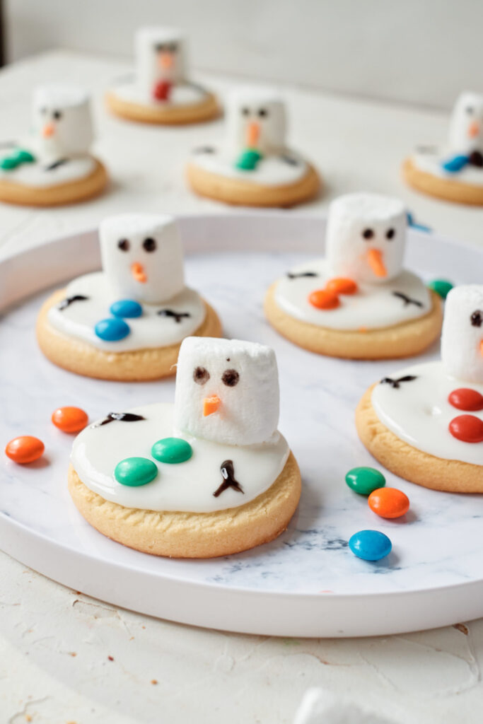 melted snowman cookies on marble serving tray 