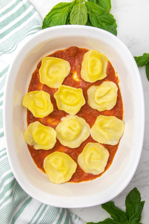 ravioli in a baking dish with sauce 