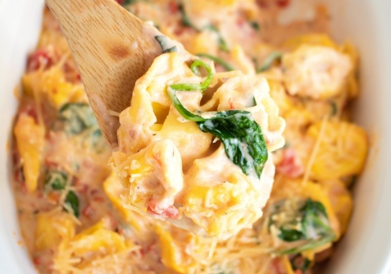 tortellini bake on a wooden spoon 