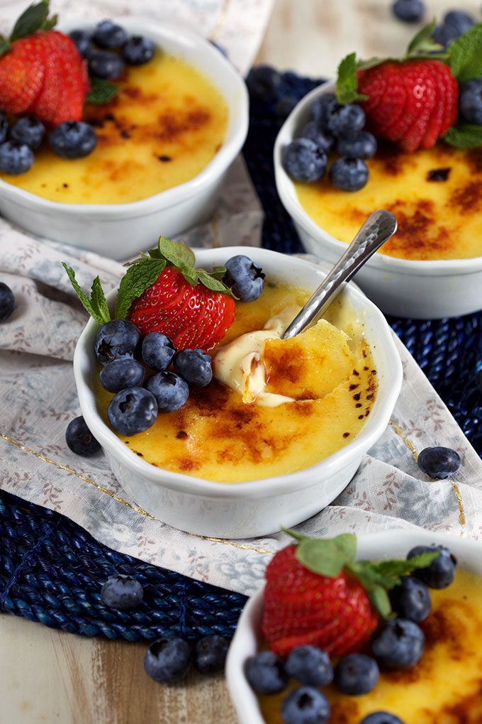 Creme Brulee with berries on top on counter 