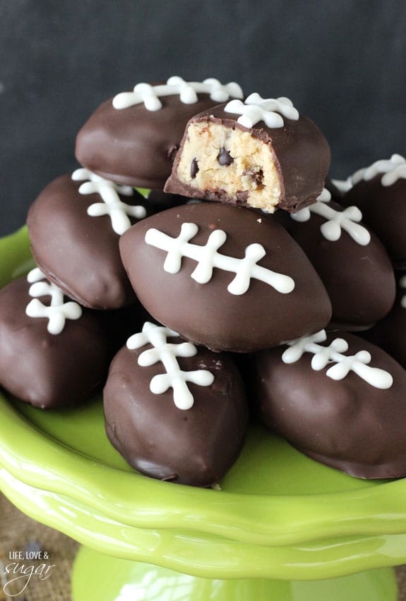 cookie dough football shaped truffles on green plate 