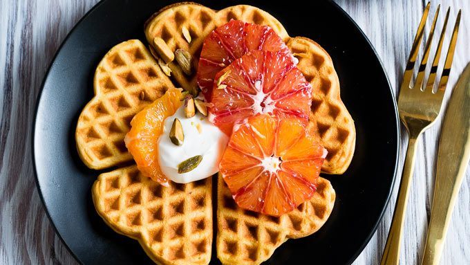 heart shaped waffles on plate with fruit on top 