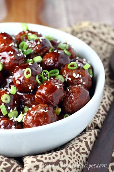 teriyaki meatballs in a bowl garnished 
