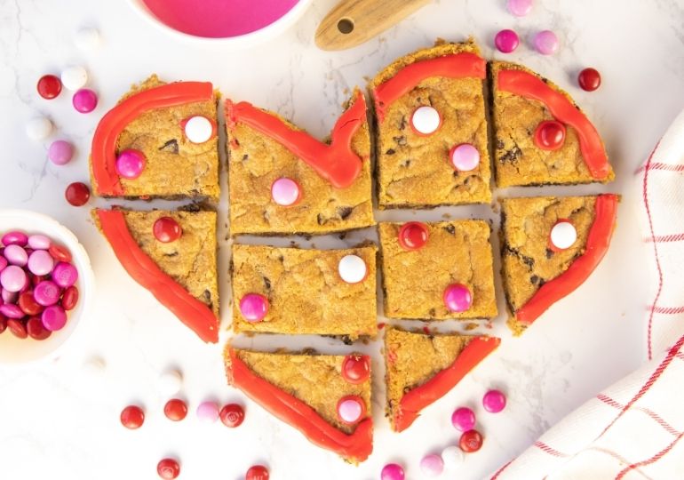 cookie cake cut up on marble counter 