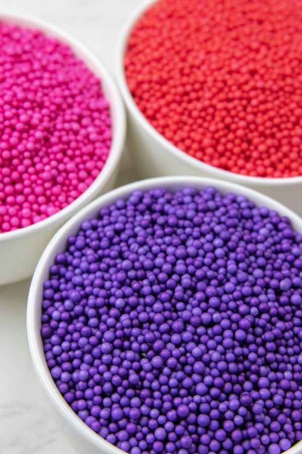 Valentine Floam is a fun and festive floam that is perfect for Valentine's Day. This is a floam hack that is a game changer! See how to make! #passion4savings #floam #diy #easy #activity #valentinesday #vday #kids #forkids foam beads in white bowls on table