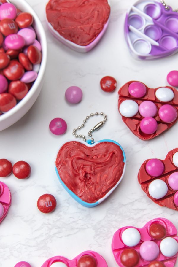 Check out this easy Valentine Pop It Candy for Kids! Use your heart shaped pop it to make a DIY chocolate treat. So easy, no bake, and fun! #passion4saving #popit #valentine #valentinesday #chocolate #diy #easy #fun #forkids heart chocolates