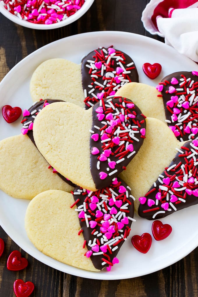 heart shaped dipped cookies on a white tray