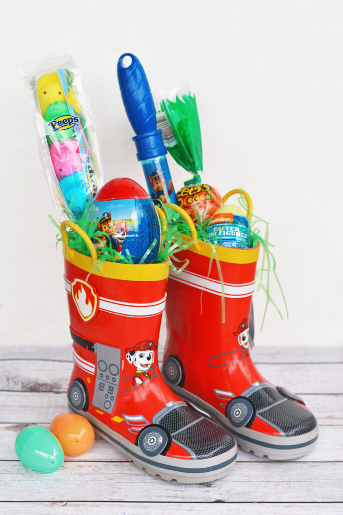 paw patrol rain boots with easter items in it 