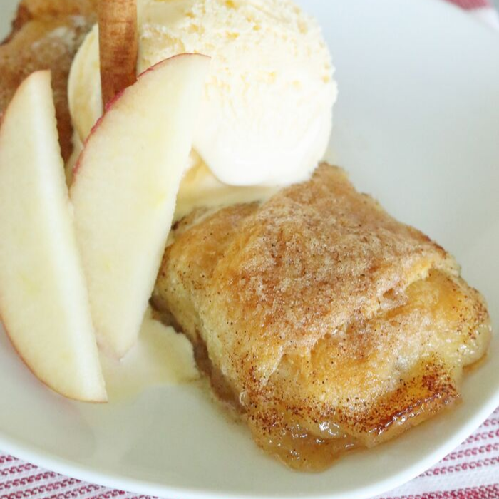 apple dumpling on plate with apples and ice cream 