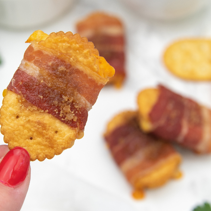 baked crackers on table and holding one in hand
