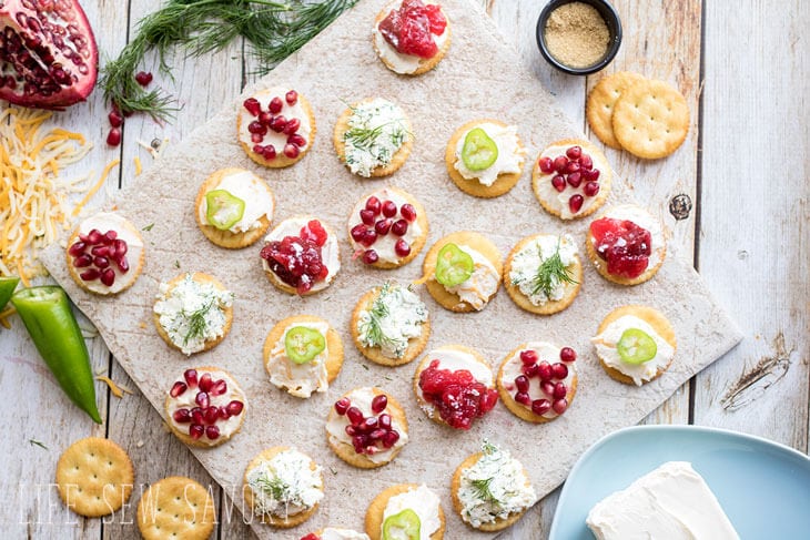 mix of crackers on table a variety of toppings 