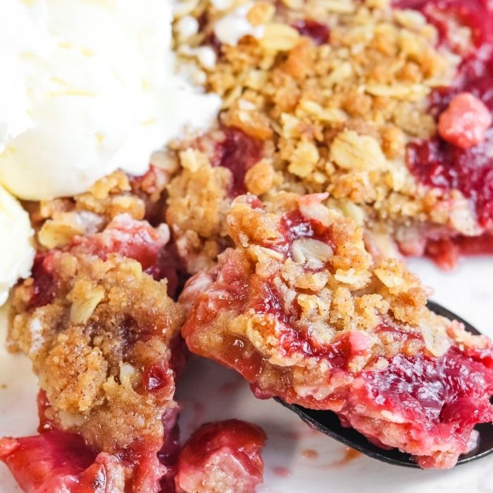 cherry cobbler on plate with fork full 