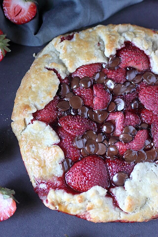 strawberry and chocolate galette on black counter 
