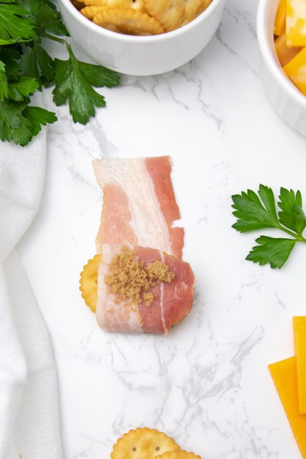 cracker appetizer showing it wrapping in bacon 