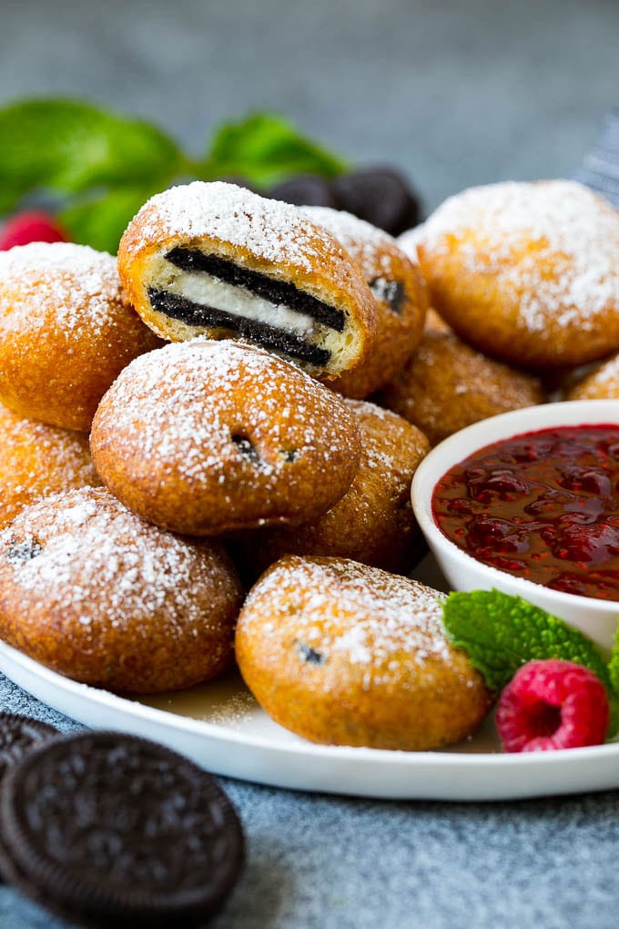 plate of deep fried Oreos with sauce on side 