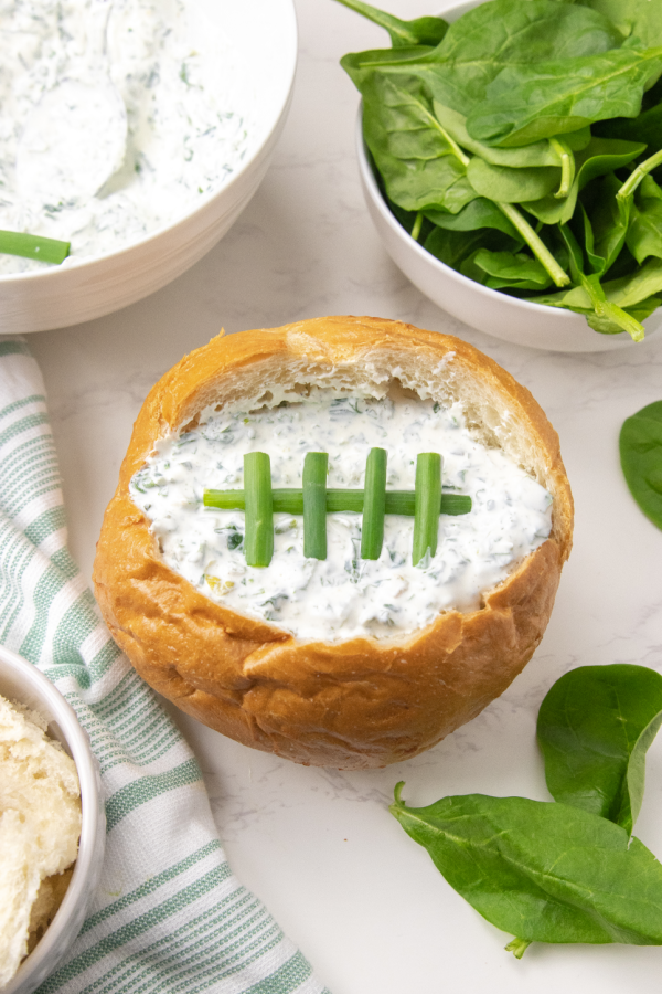 overhead shot of bread bowl shaped like football on table 