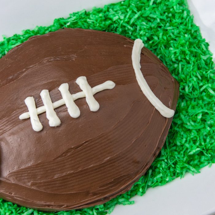 football cake with coconut around it on platter 