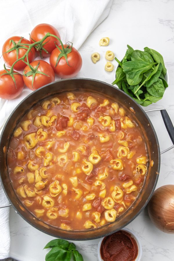 tomato basil tortellini soup in pot on counter 