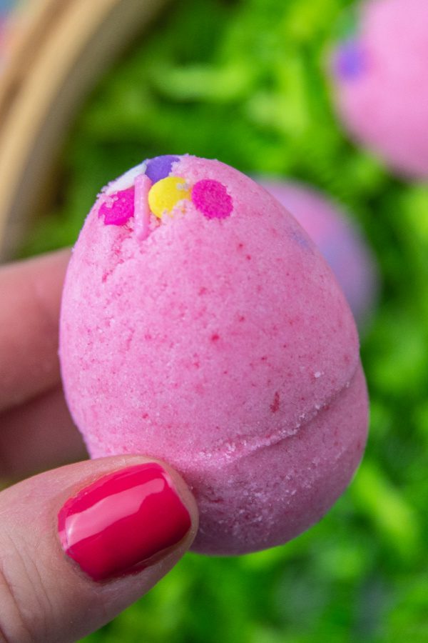 holding an easter egg shaped bath bomb