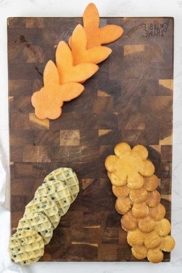 cutting board with pancakes and waffles on it 