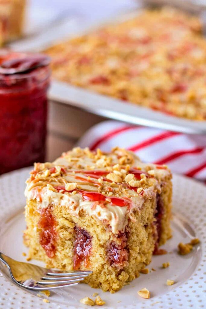 peanut butter jelly poke cake on plate 