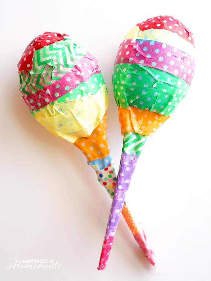 maracas made with plastic eggs on white counter 