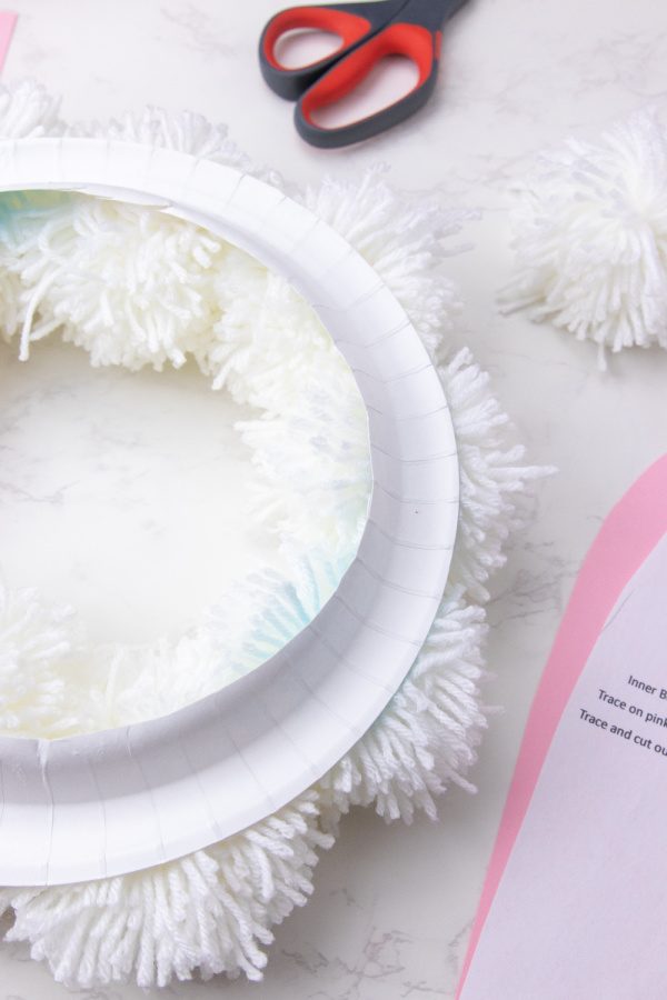 plate with poms glued on it 