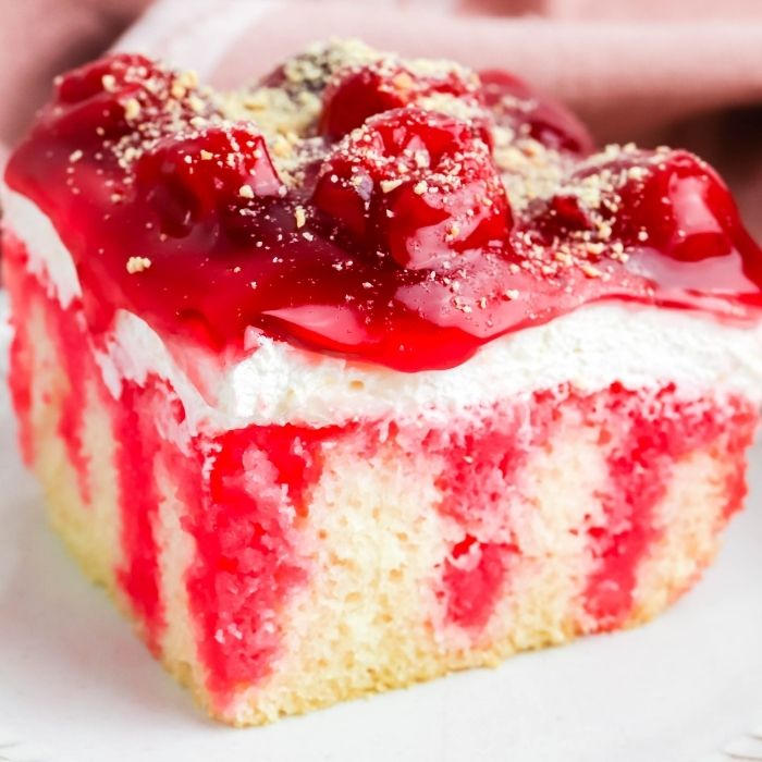 cherry poke cake on a plate