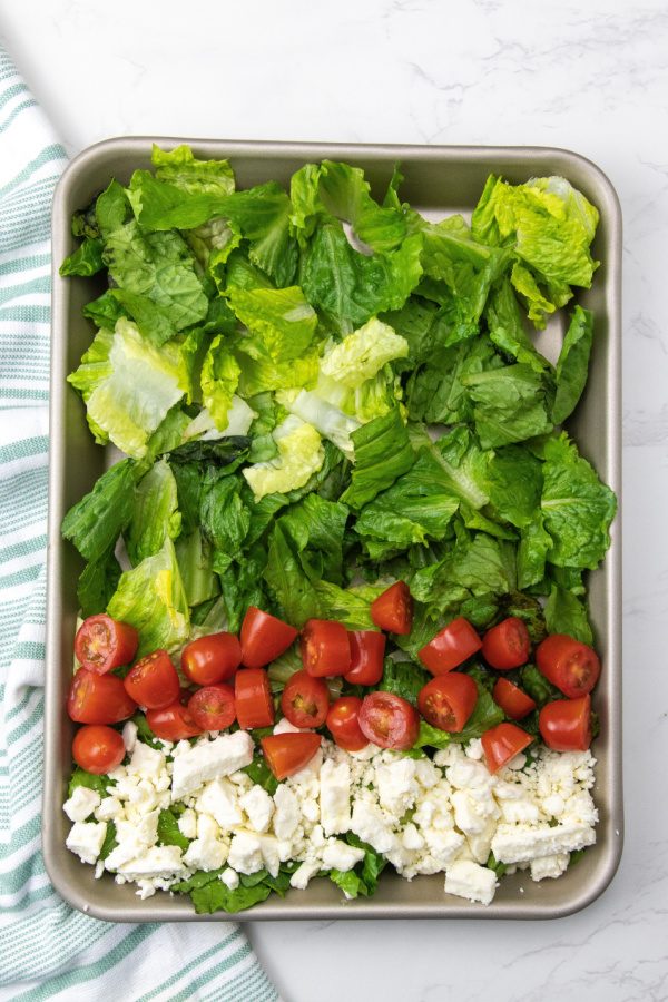 Sheet Pan Cobb Salad For A Crowd that is ready in no time. Tender chicken, loads of veggies, eggs, cheese and dressing. A must try. #passion4savings #cobb #salad #dinner #healthy #foracrowd #dinner #lunch #easy overhead feta and tomatoes on salad greens