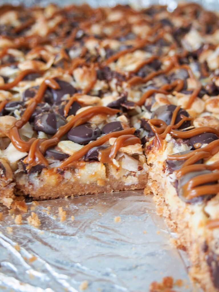 caramel apple bars with slice out of pan 
