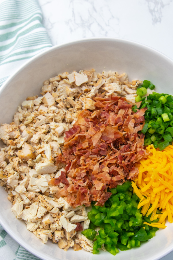 Jalapeño Popper Chicken Salad is a spicy and creamy chicken salad. Loaded with jalapenos, cheese, chicken, and more. A must make lunch idea. #passion4savings #chicken #spicy #jalapeno #popper #dinner #Lunch chicken salad in a bowl