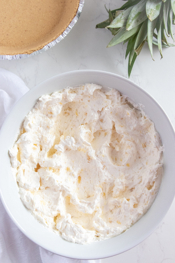 creamy pineapple pie filling in a white bowl