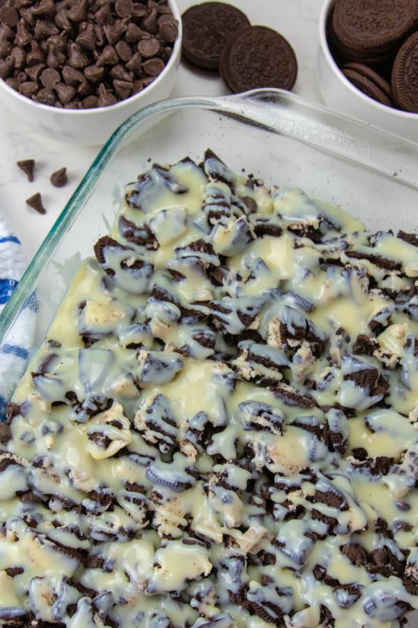 Oreo Magic Bars take minutes to make, and are delicious sweet magic bars. Loaded with cookies and cream bars, Oreos, chocolate chips and more. Give this easy Oreo cookie recipe a try today. #passion4savings #oreo #cookiesandcream #easy #quick #partyfood #dessert magic bars with condensed milk