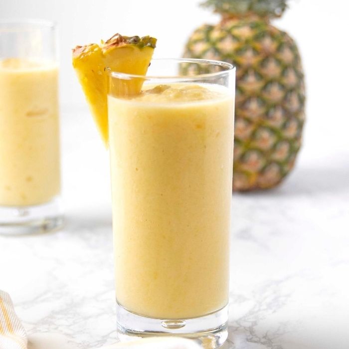 pineapple smoothie in glass on table 