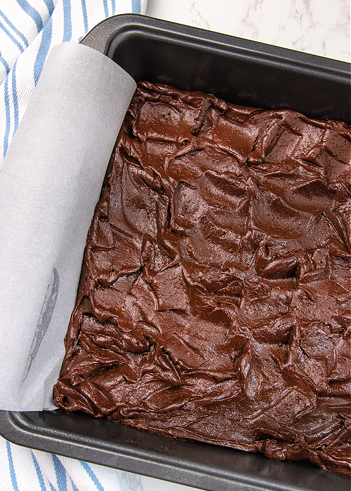 Brownie batter in a square pan