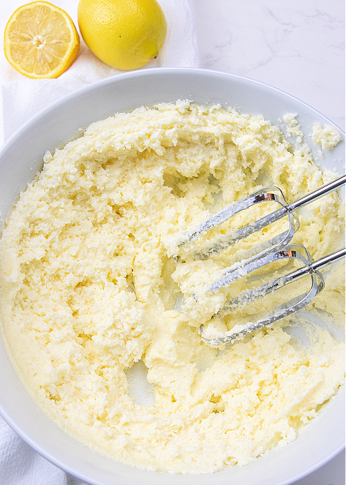 Butter creamed with the mixer in a white bowl