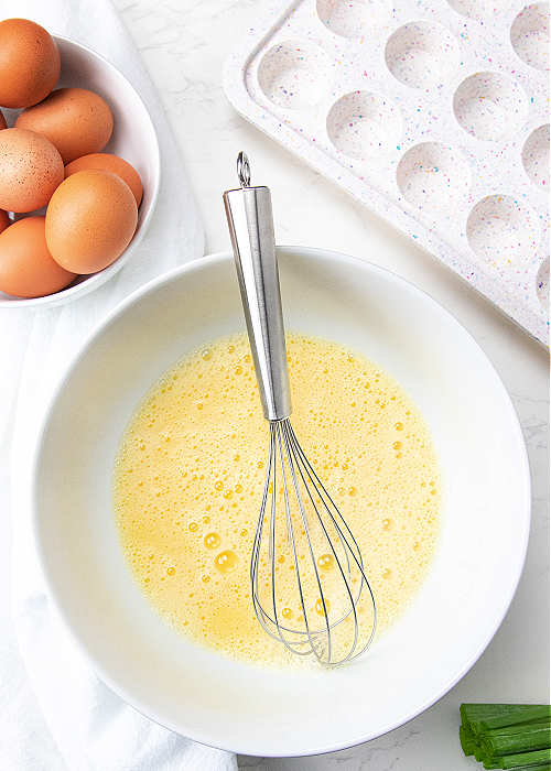 eggs and milk whisked together in a mixing bowl