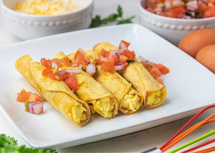 four breakfast taquitos on a plate