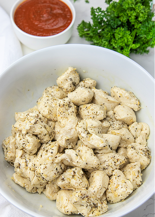 biscuits and italian seasoning in a mixing bowl