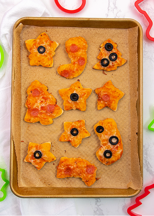 holiday mini pizzas on a baking sheet